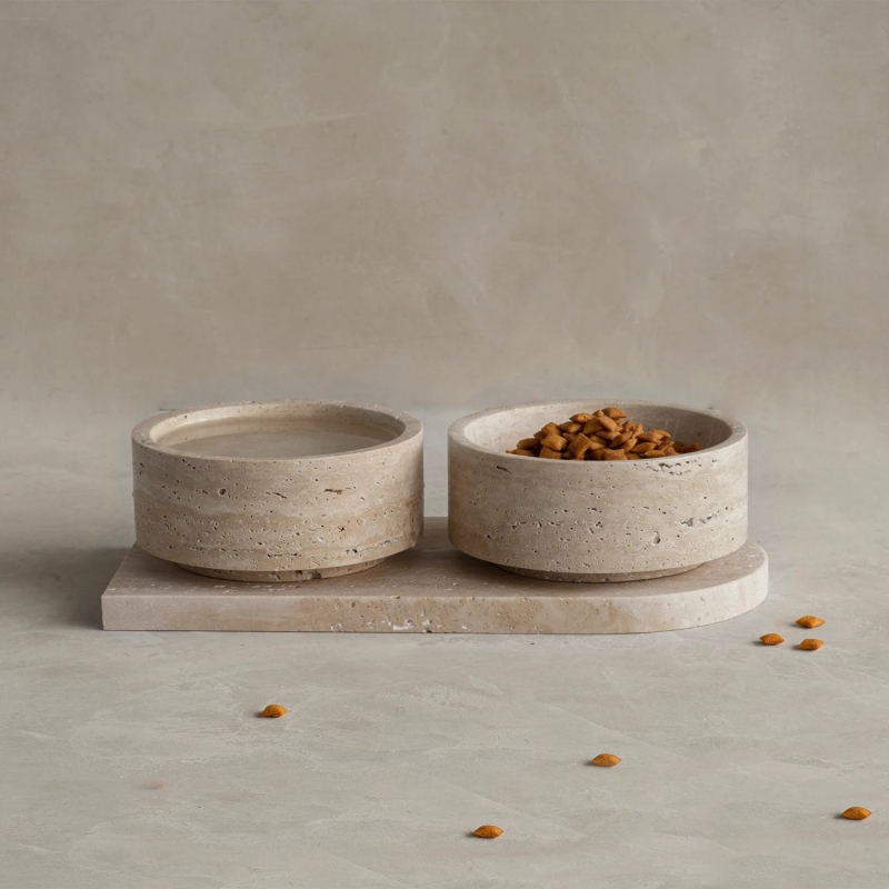 Beige travertine pet bowl set with two bowls on tray - filled with dry cat food