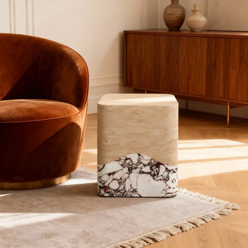 Travertine and Calacatta Voila Marble side table next to velvet chair