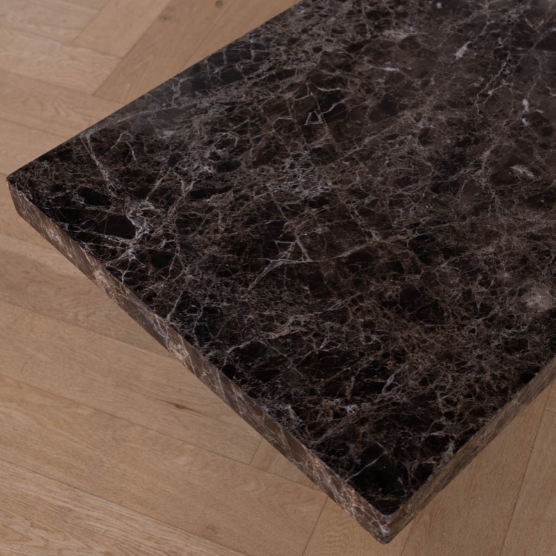 Close-up of Dark Emperador marble texture on coffee table - natural stone vein detail