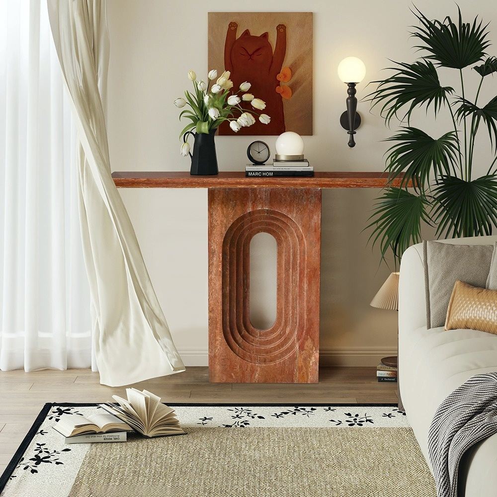 Red travertine console table with architectural arch design in a modern living room setting