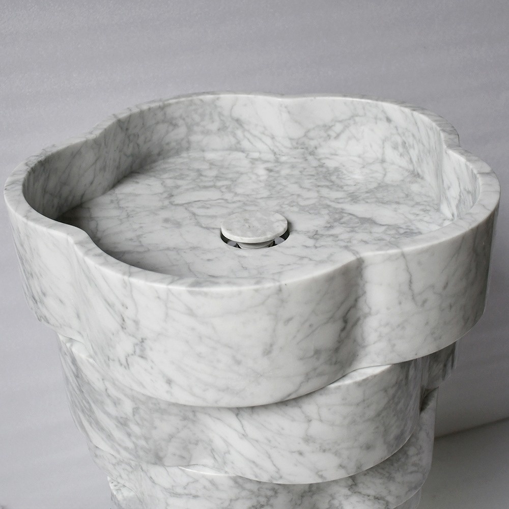 Stacked scalloped marble pedestal sink with LED light - minimalist sculptural bathroom design